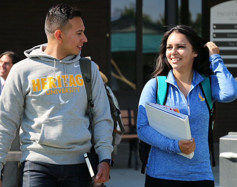 Male and Female Students Walking On Campus