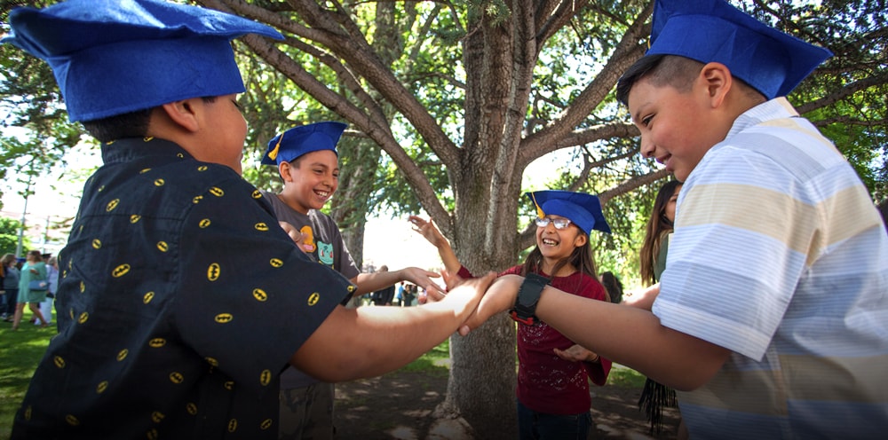Kids playing with graduation caps on