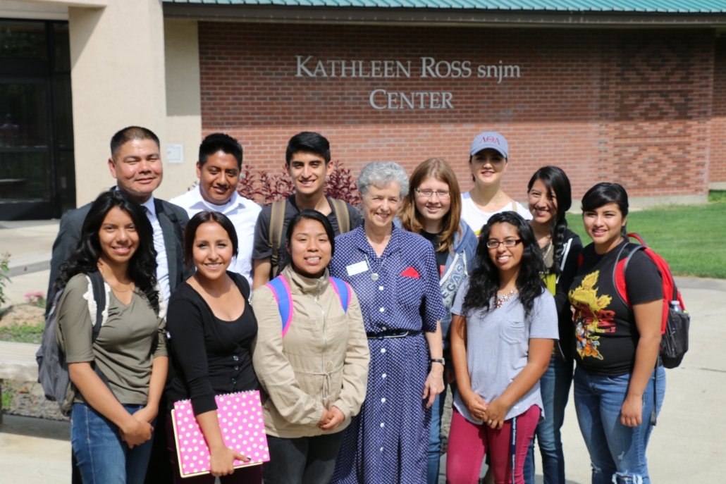 Sister Kathleen standing outside the Ross Center with a group of students