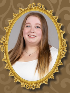 A smiling young blond woman pictured in a mirror frame