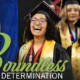 A student dressed in a cap and gown with a big smile at a graduation ceremony surrounded by other graduates