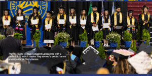 Graduating students holding certificates while on stage