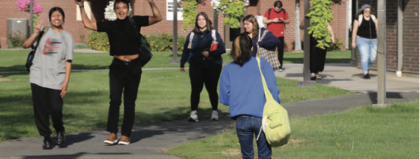 Students walk along a path at Heritage University