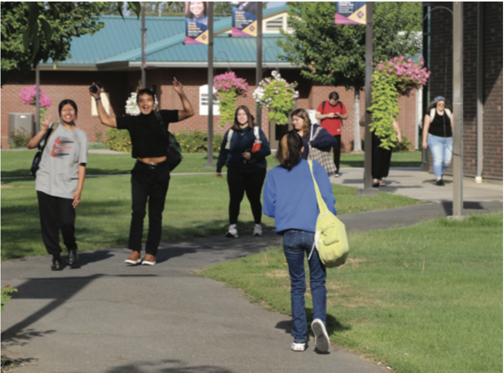 Students walk along a path at Heritage University