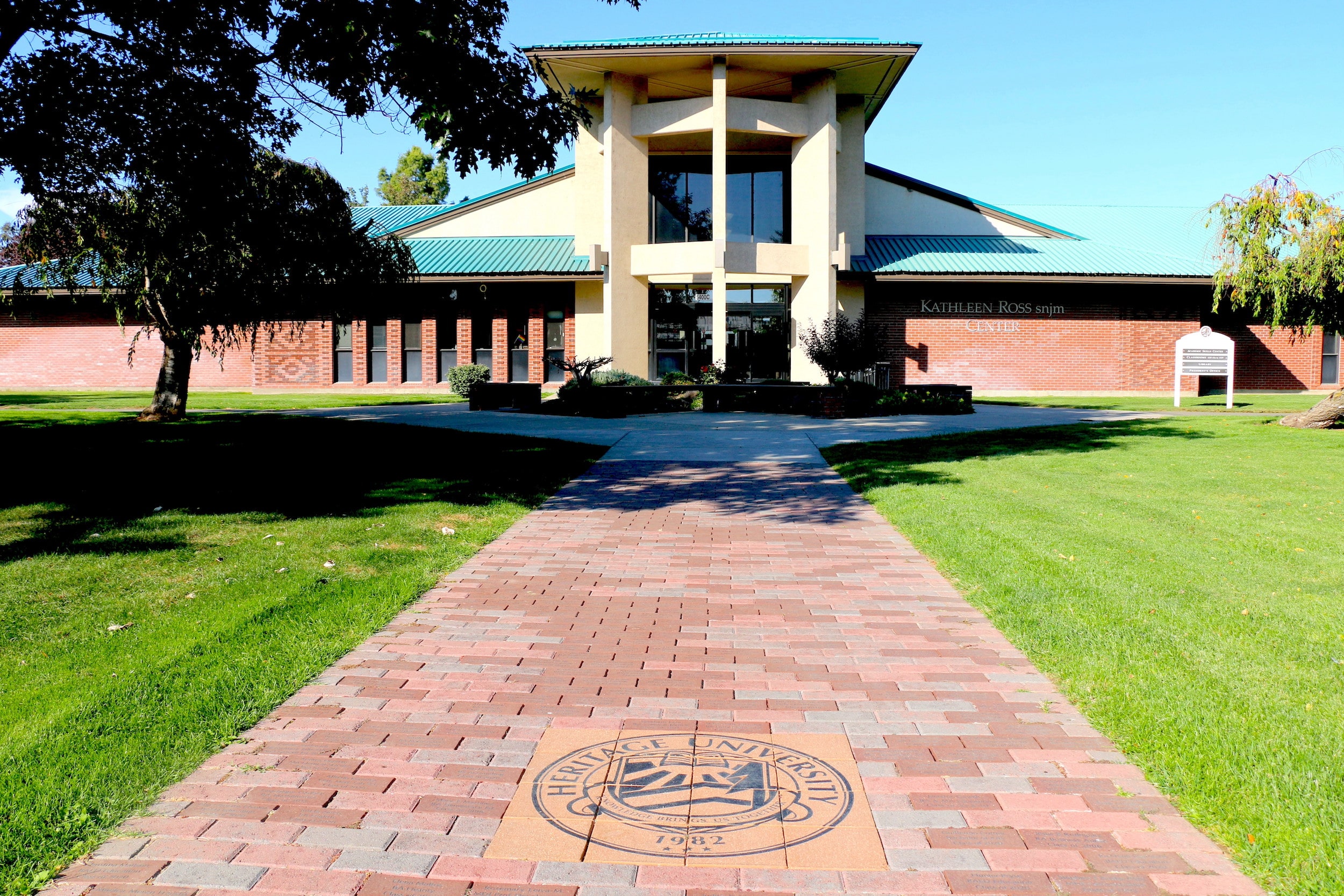 A well-maintained brick walkway meanders through a lush garden, inviting visitors to explore the serene surroundings.