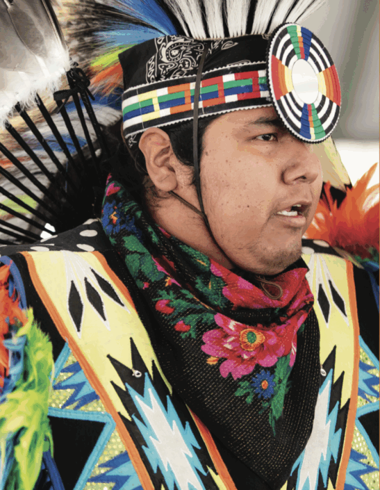 Wings_Summer2025_DDT_1 A person wearing a colorful headdress