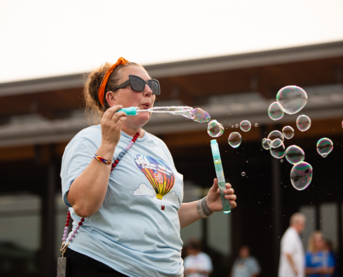 HeritageRiseUp-EW-04 A person blowing bubbles outside