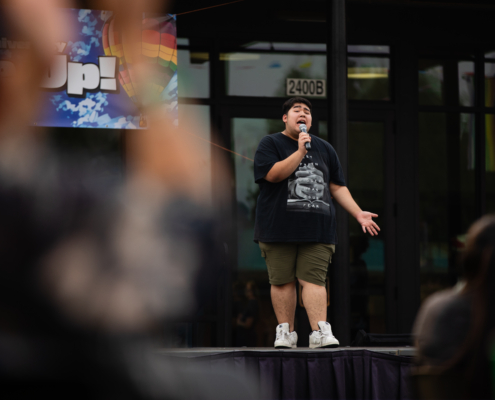 HeritageRiseUp-EW-06 A person on a stage singing into a microphone