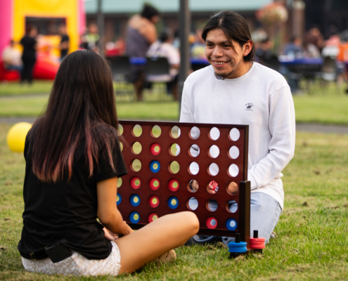 HeritageRiseUp-EW-08 Two people playing a connect four game