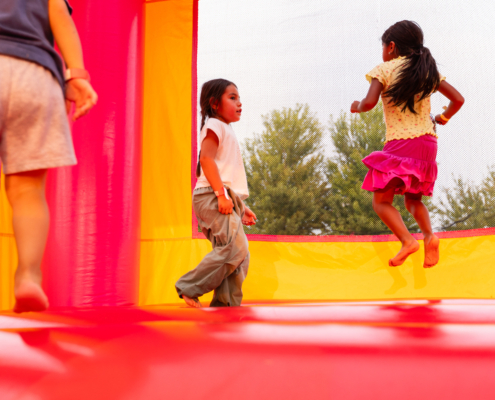 HeritageRiseUp-EW-29 A group of kids jumping on a bounce house