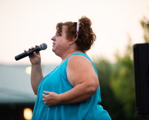 HeritageRiseUp-EW-34 A person holding a microphone