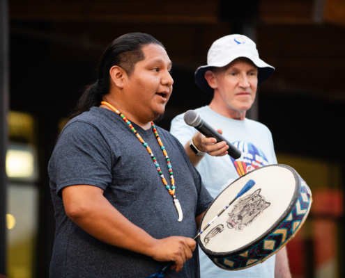 HeritageRiseUp-EW-36 A person holding a microphone and another holding a drum