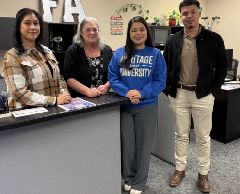 A group of people standing in a room.