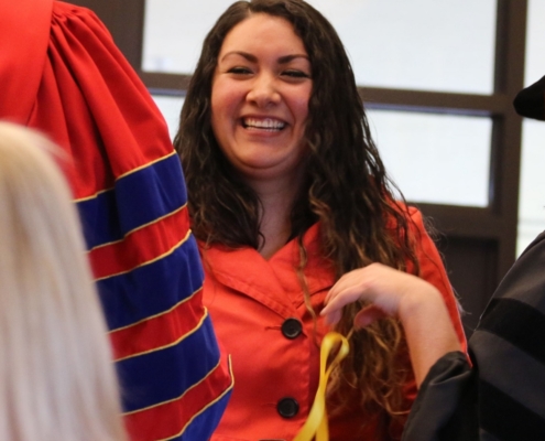 A woman smiling at a ceremony