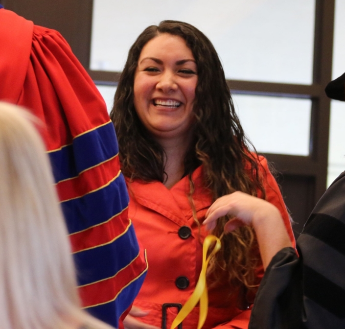 A woman smiling at a ceremony