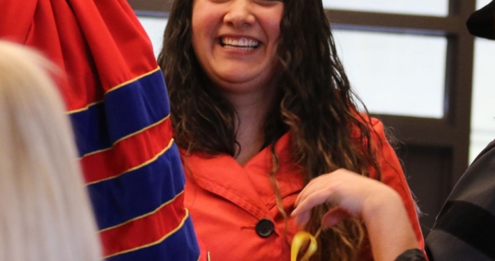 A woman smiling at a ceremony