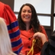 A woman smiling at a ceremony