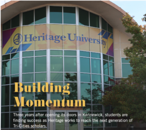 Photograph of Heritage University building featuring large glass windows and a colorful banner with university name. Text overlay highlights "Building Momentum," noting student success three years after opening in Kennewick and efforts to reach next generation of Tri-Cities scholars.