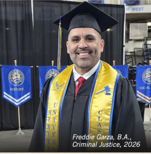 Photograph of a smiling male graduate wearing a black cap and gown with a gold stole featuring blue symbols and text, standing indoors at a graduation ceremony. Blue banners labeled "HISTORY" and "SOCIAL" hang in the background, indicating academic departments, while text overlay identifies the graduate as Freddie Garza, B.A., Criminal Justice, 2026.