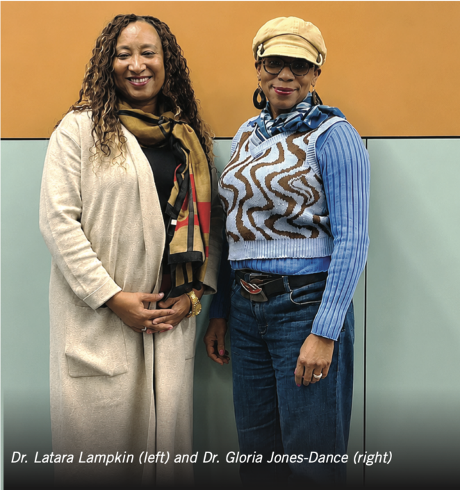 Photograph of two women standing side by side against a two-tone orange and light blue background, identified as Dr. Latara Lampkin on left and Dr. Gloria Jones-Dance on right. Both are dressed casually, with Dr. Lampkin wearing a beige cardigan and patterned scarf, and Dr. Jones-Dance wearing a blue ribbed shirt, patterned vest, beige cap, and sunglasses.